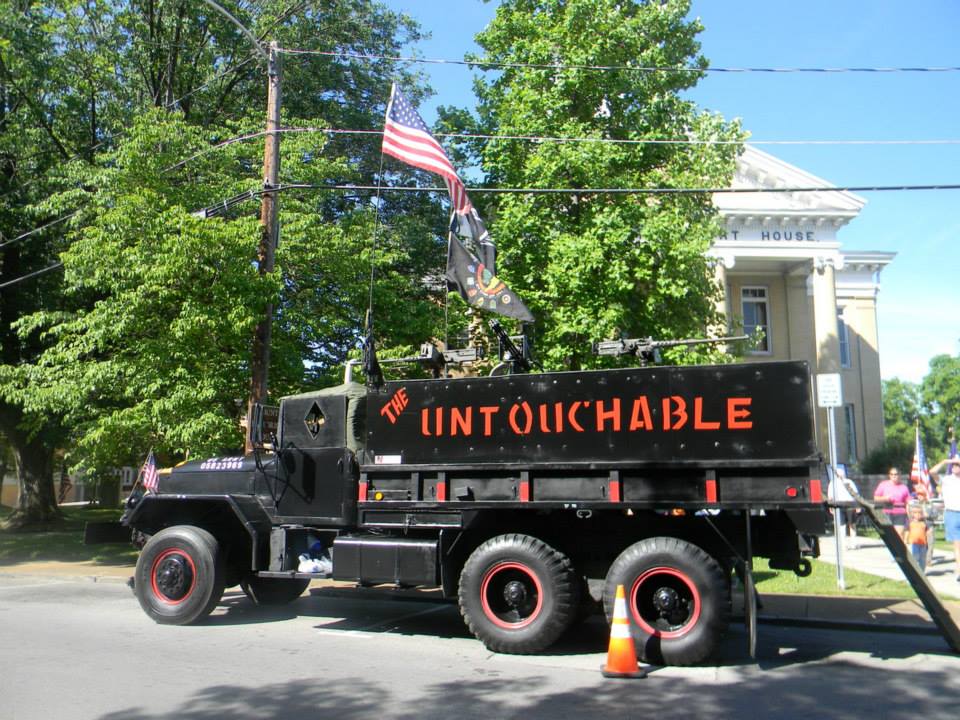 Image of black tank like truck with orange writing "the Untouchables"